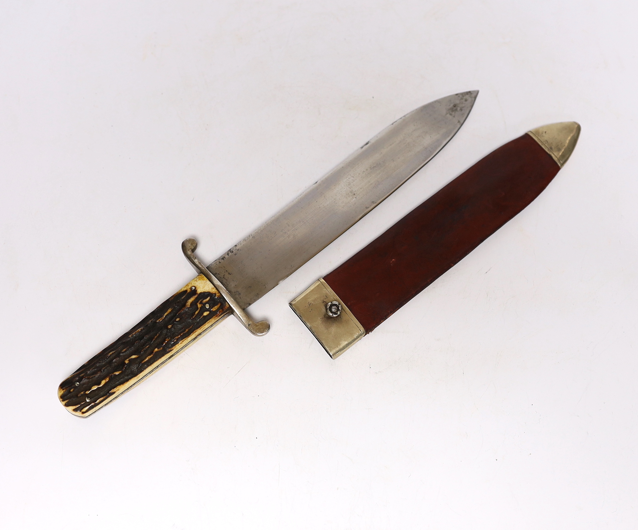 A John Wilson 19th century Bowie knife, spearpoint blade, stamped hand, forged, J, Wilson Sycamore Street, Sheffield, with peppercorn and diamond trade marks, horn, grip, and red leather scabbard with rose pattern stud,